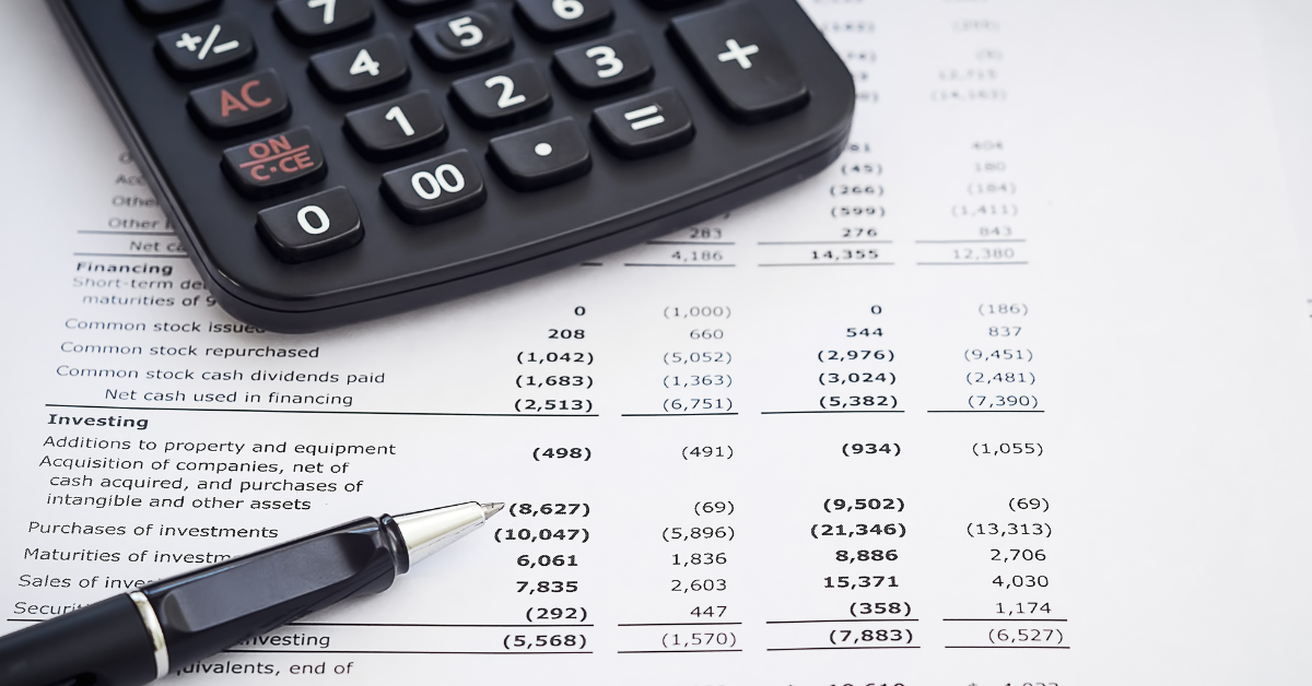 client financial statements on desk with a calculator and pen
